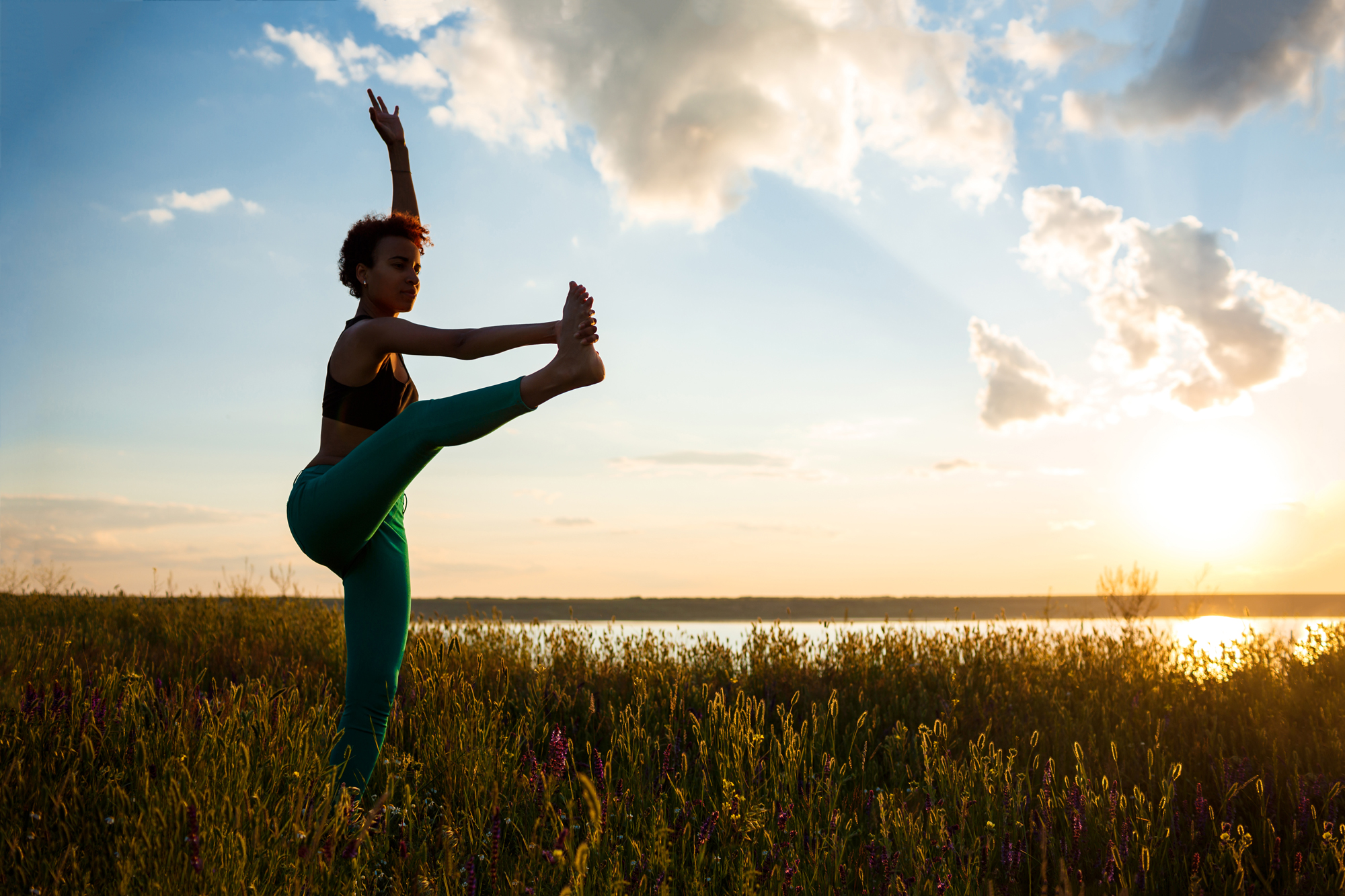 silhouette-sportive-girl-practicing-yoga-field-sunrise