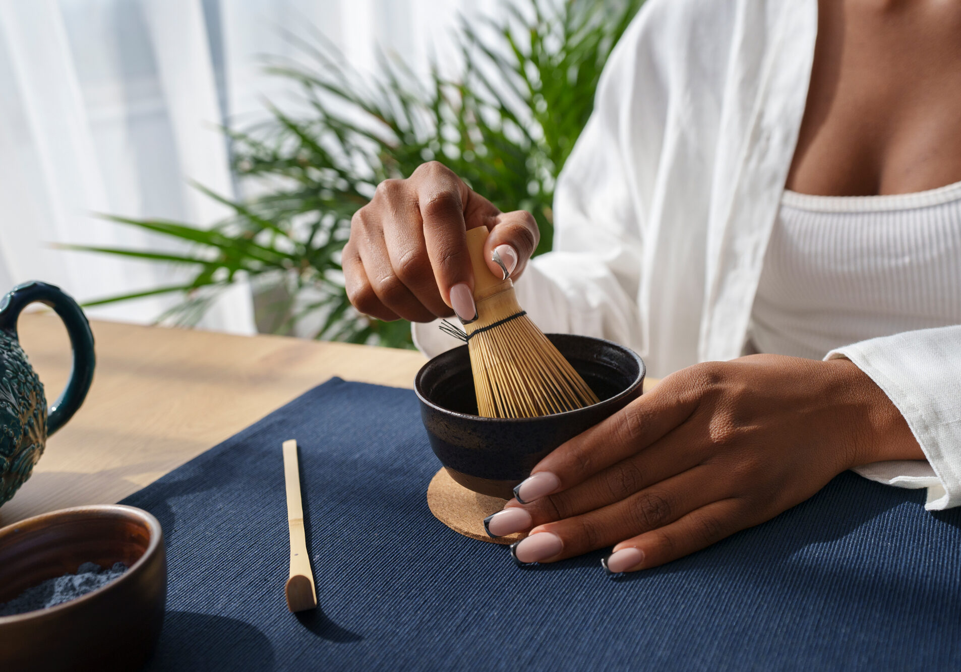 front-view-woman-preparing-blue-matcha-home